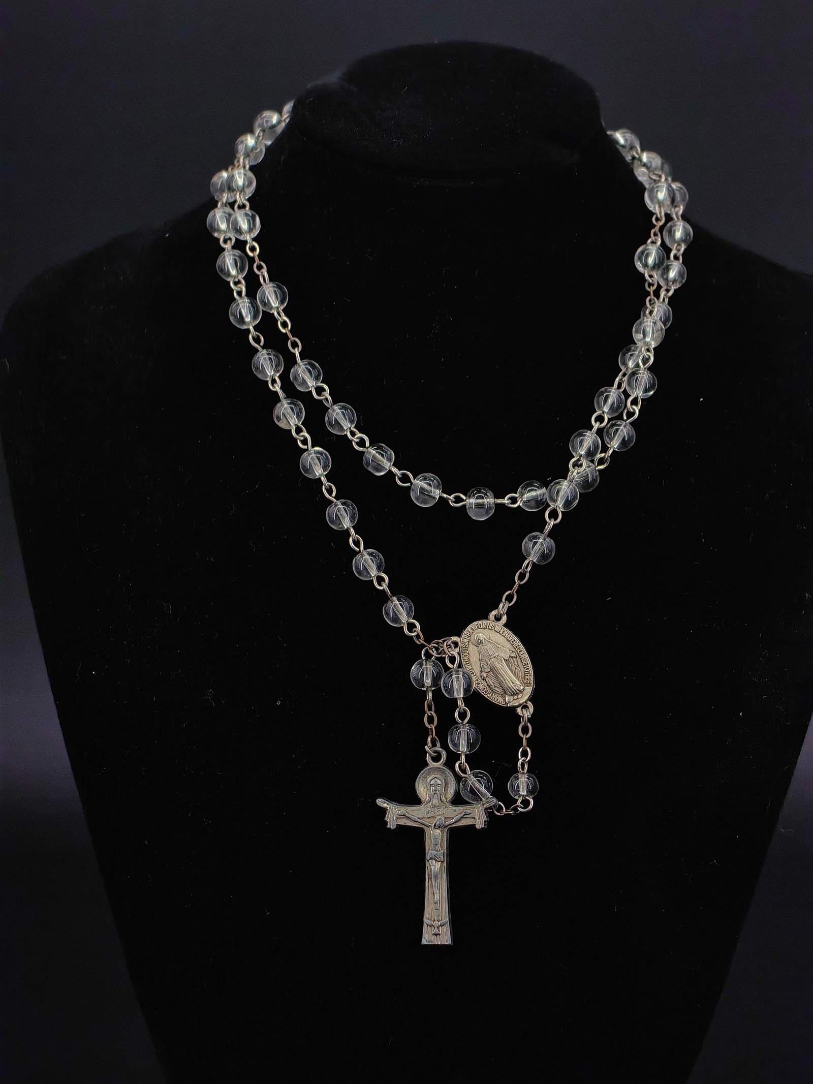 An Antique Rock Crystal Rosary Necklace,: An exquisite antique rock crystal (or clear glass) rosary necklace, featuring beautifully polished, translucent beads. It is adorned with a finely detailed Miraculous Medal of the Virgin Mary and an