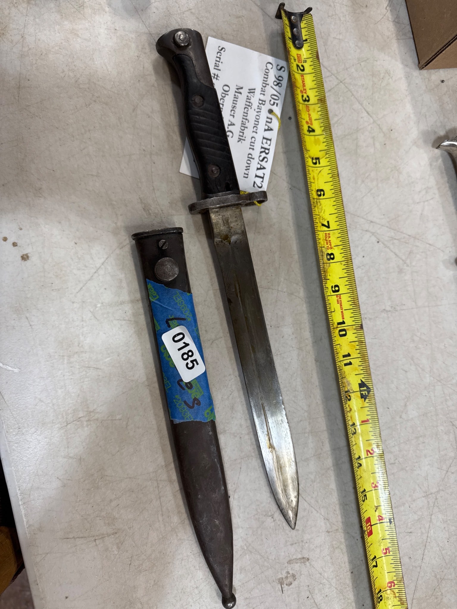 Military Bayonet with Scabbard: Military bayonet marked 'S98/05 nA ERSATZ2 Combat Bayonet Cut Down', manufactured by Waffenfabrik Mauser A.G. Oberndorf. Serial number 1666 on pommel. Includes scabbard. All items are sold AS IS, WHER