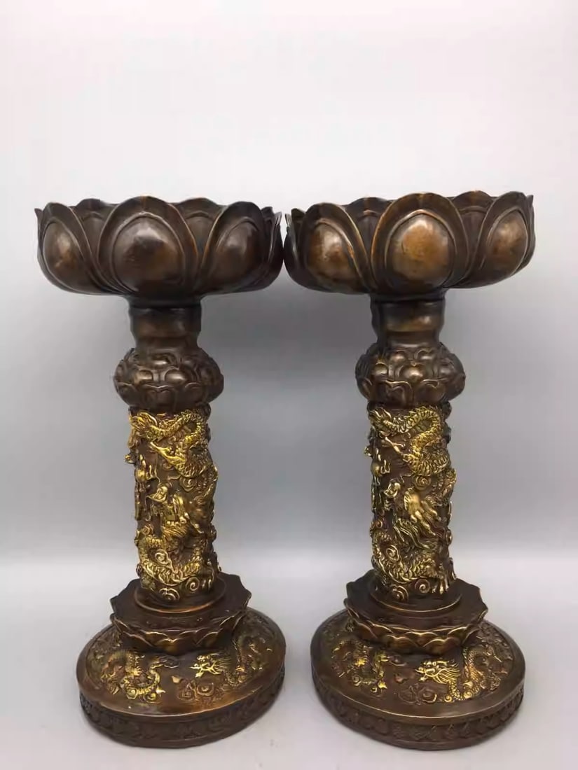 A pair of pure copper, gold-plated candle holders with flying dragon and lotus flower motifs: Dimensions: Width 13cm, Height 28cm Weight: 4800g