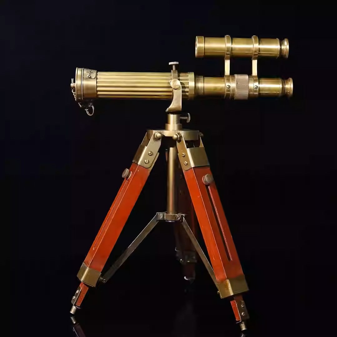 Brass binoculars with a three-legged wooden stand: Dimensions: Length 23cm, Height 32cm Weight: 758g
