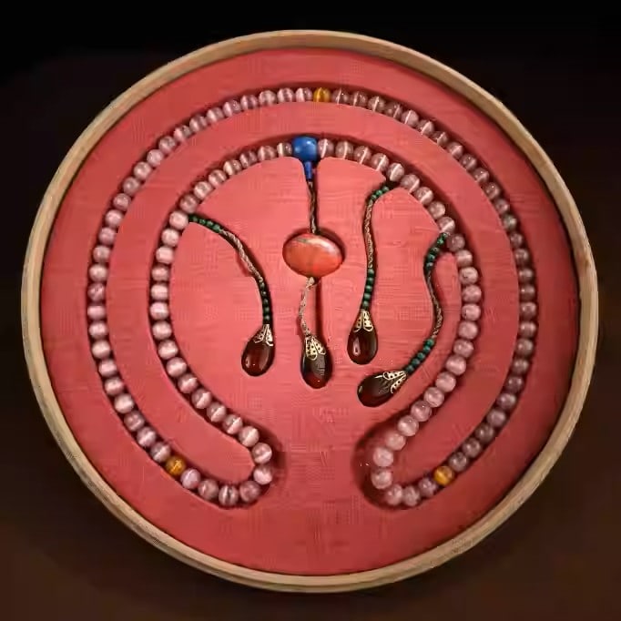 A string of pink cat's eye gemstone prayer beads from the Qing Dynasty (1 of 5)