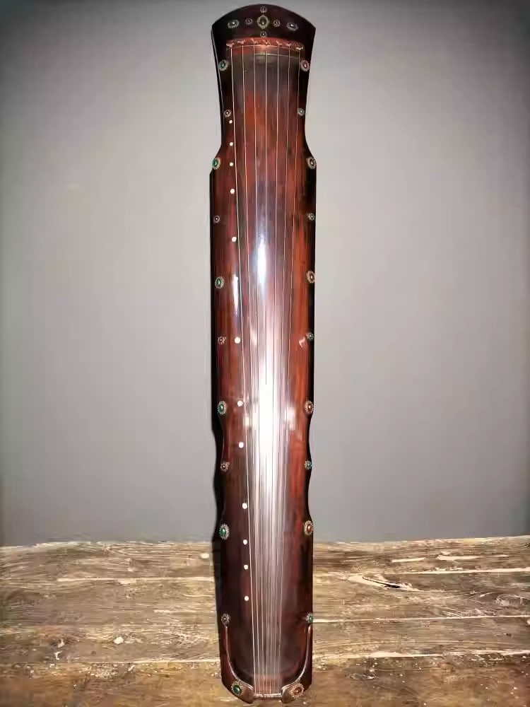 A seven-stringed zither made of wood, lacquered and inlaid with gemstones: Dimensions: Length 123cm, Width 20cm, Height 6cm Weight: 2150g