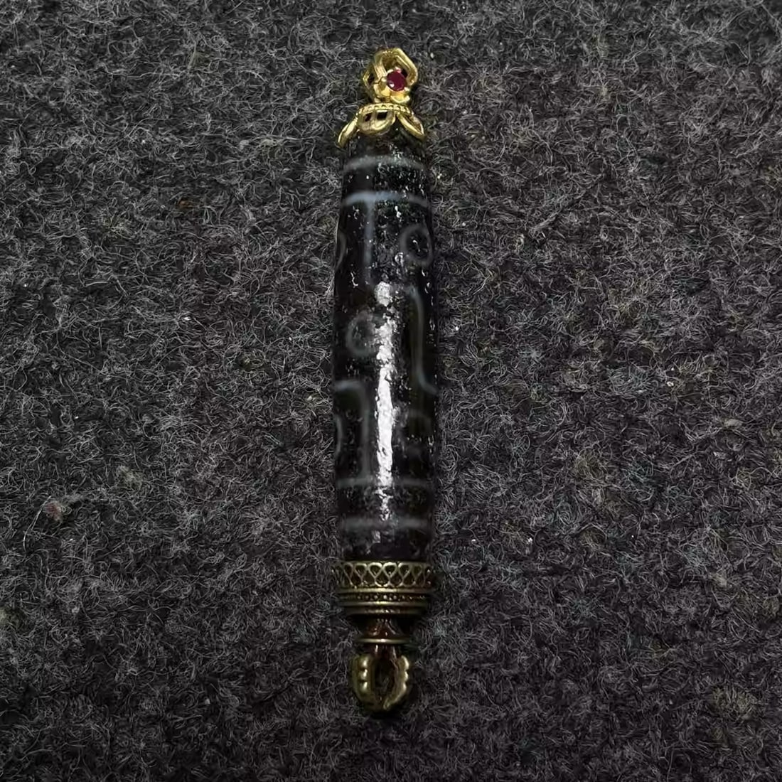 A rosewood box inlaid with mother-of-pearl contains an agate dzi bead pendant: Box Dimensions: Length 15cm, Width 10cm, Height 7cm