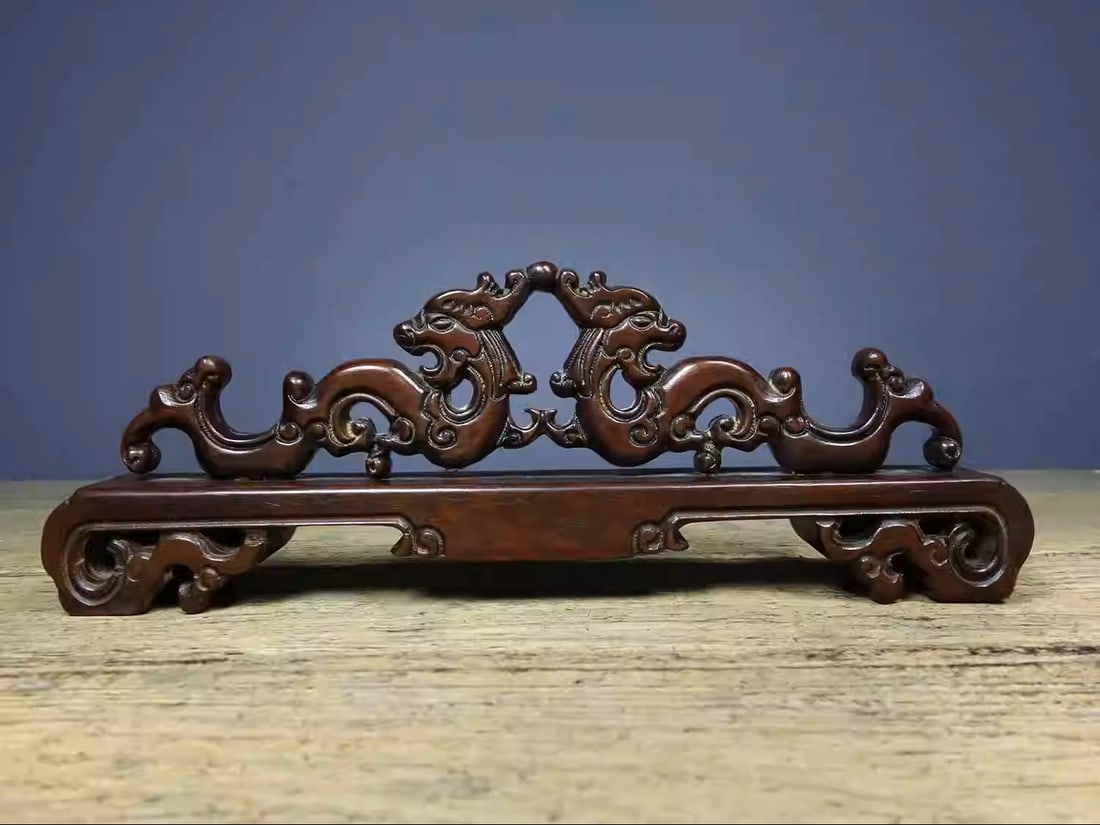 Rosewood pen holder intricately carved with a design of two dragons presenting auspicious symbols: Dimensions: Length 26cm, Width 3cm, Height 9.5cm Weight: 290g