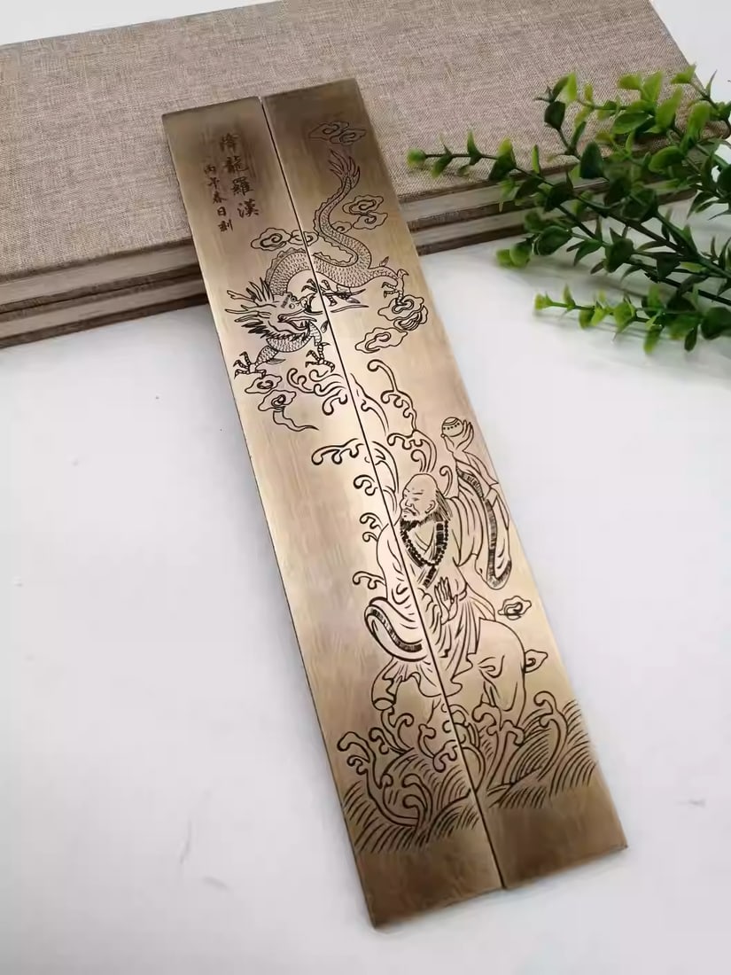 Pure copper intricately carved Arhat Subduing the Dragon paperweight: Dimensions: Length 28cm, Width 4cm, Thickness 0.7cm, Weight: 1100 grams