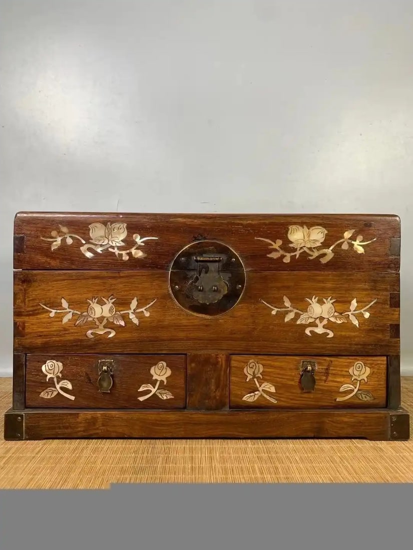 Rosewood storage box inlaid with mother-of-pearl floral and bird motifs: Length 41 cm, width 25 cm, height 23 cm.