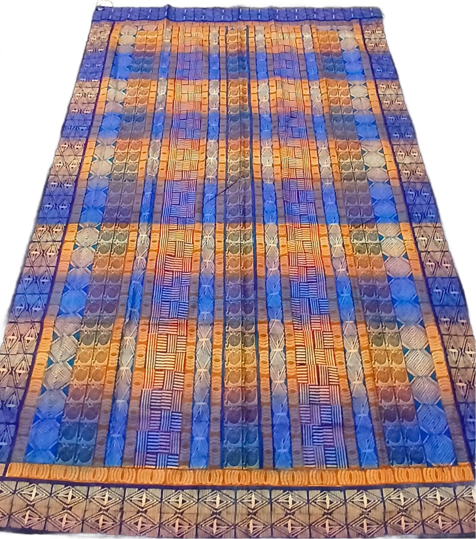 Tapestry / Tablecloth: Kudhinda’s designs are inspired by local Zimbabwean culture and are characterized by vibrant colors and clashing patterns. Organized by neat lines and rows that form grids some Kudhinda designs are