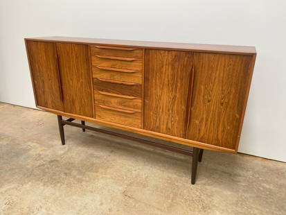 Danish Rosewood Sideboard: Beautiful Danish rosewood sideboard. Attributed to Gunni Omann. Cabinet features 4 doors that open to reveal ample storage space. 1960's.