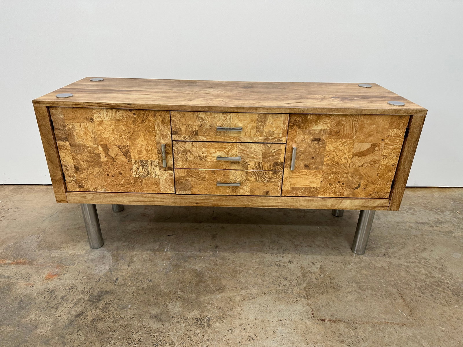 Burl Credenza: Burl laminate credenza. 3 drawers. This piece has a finished back. 1970s.