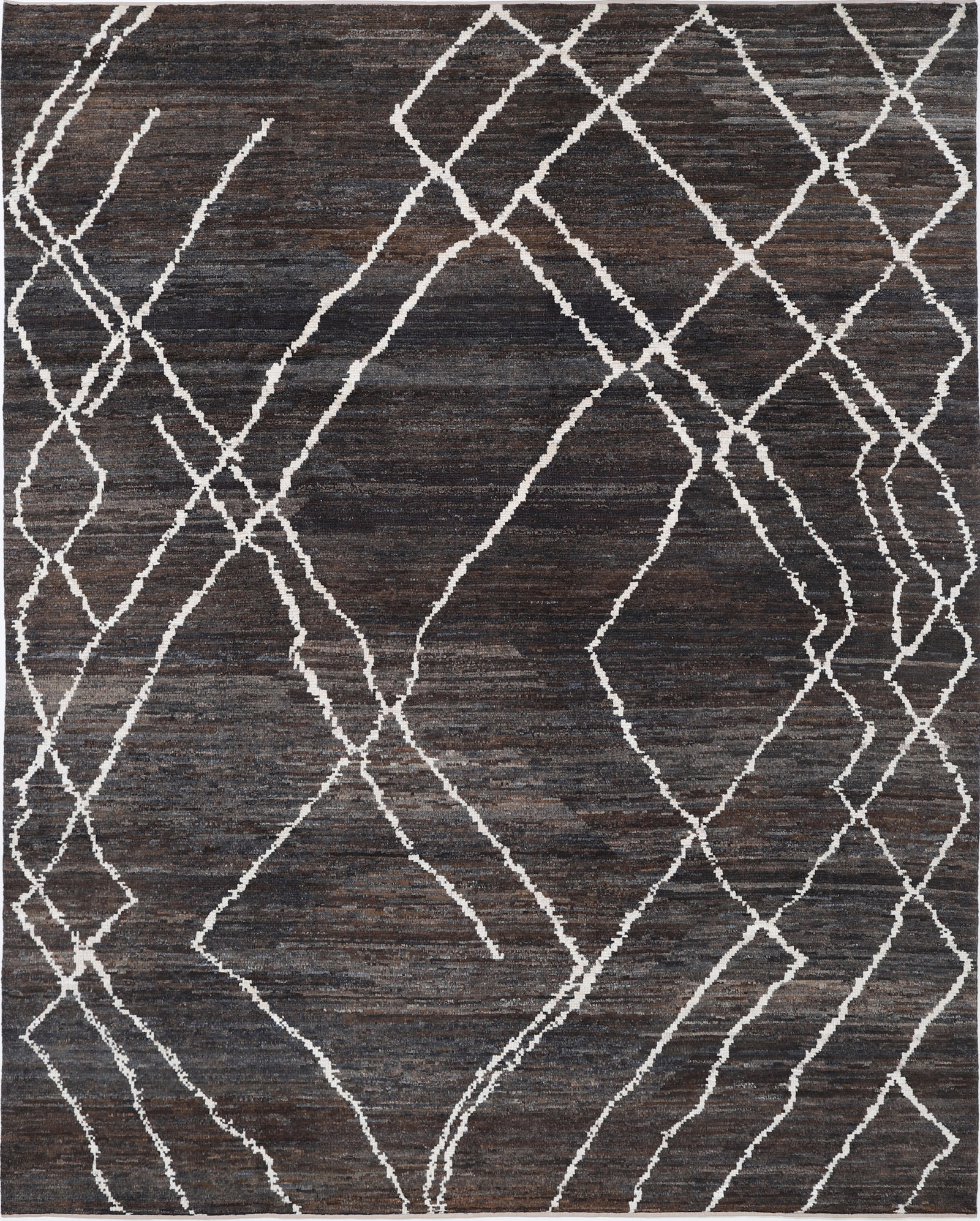 Fine Hand Knotted Morocan Wool Rug - 10'1" x 8'2": Hand-knotted in Afghanistan, this wool rug from the Morocan collection stretches 10?1? by 8?2? in a timeless rectangular form, where bold tribal motifs unfold in a tapestry of rich, earthy tones. The 