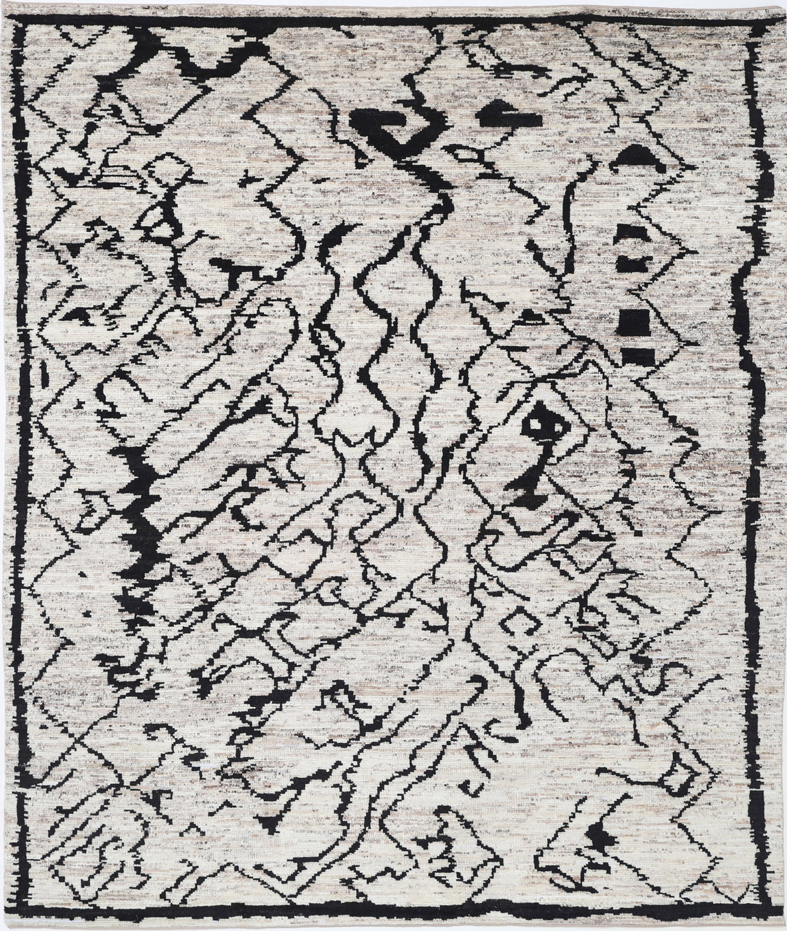 Hand Knotted Morocan Wool Rug - 9'9" x 8'2": Handcrafted in Afghanistan, this hand-knotted wool rug from the Morocan collection measures 9?9? by 8?2? in a classic rectangular shape. It features striking tribal designs, showcasing bold geometric 