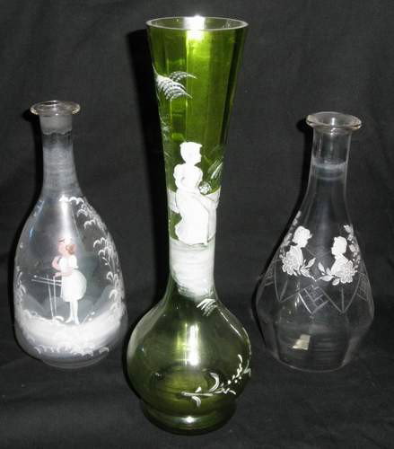 Three pieces of Bohemian Glass: Hand blown and hand painted vases Mary Gregory design. Tall green glass and two clear glass