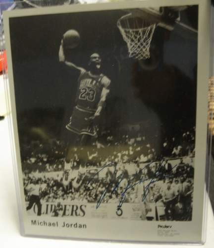 Massive Michael Jordan Lot: autographed photo, 1000's of Jordan items, including over 2000 different cards, many UDA items, over 300 publications, cookie jar, dolls, lunch boxes, framed prints, and 1992 Kraft life size Dream Tea