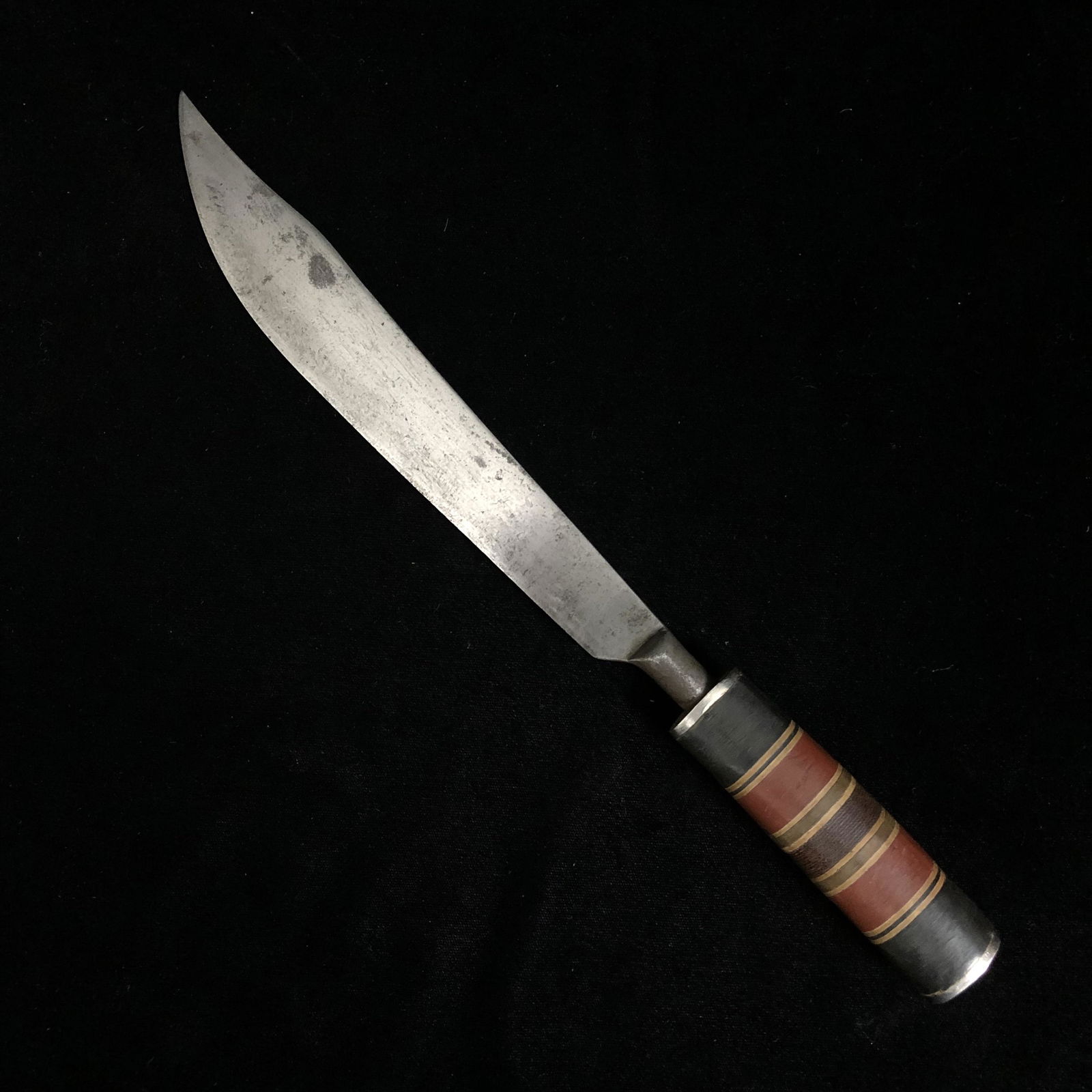 WWII Theater Made Trench Art Knife: WWII theater made fixed blade trench art fighting knife. Carbon steel blade most likely made from an old metal file; grip is made of aluminum, Bakelite and micarta. Grip and knife are solid. Sorry, no