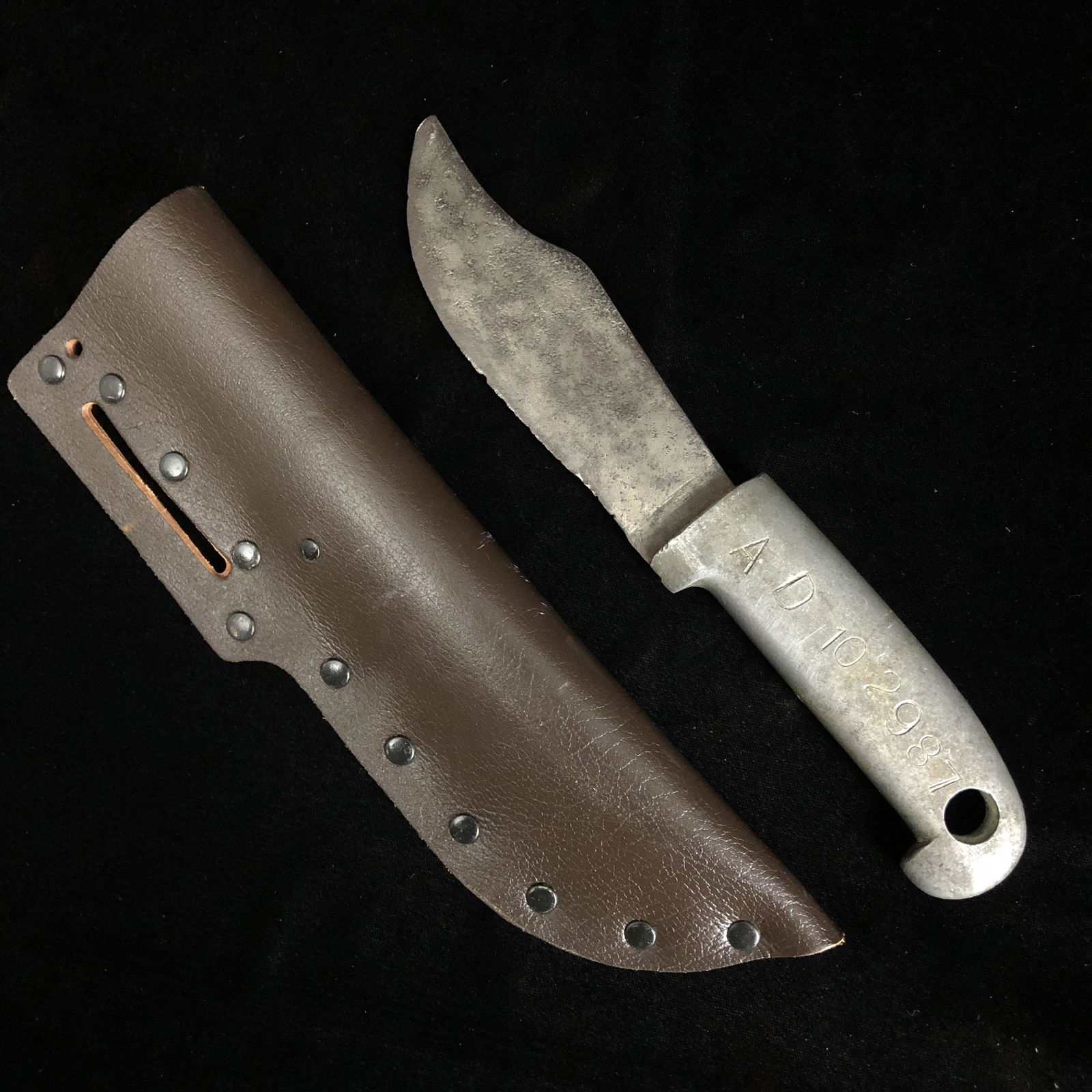 WWII Theater Made Crude Chubby Fighting Knife: WWII short chubby trench art theater made fixed blade knife with the following stamped in to the cast aluminum grip ÒAD 10-29-87, AD 10-12-43Ó itÕs anyones guess what that means. Comes in a post wa