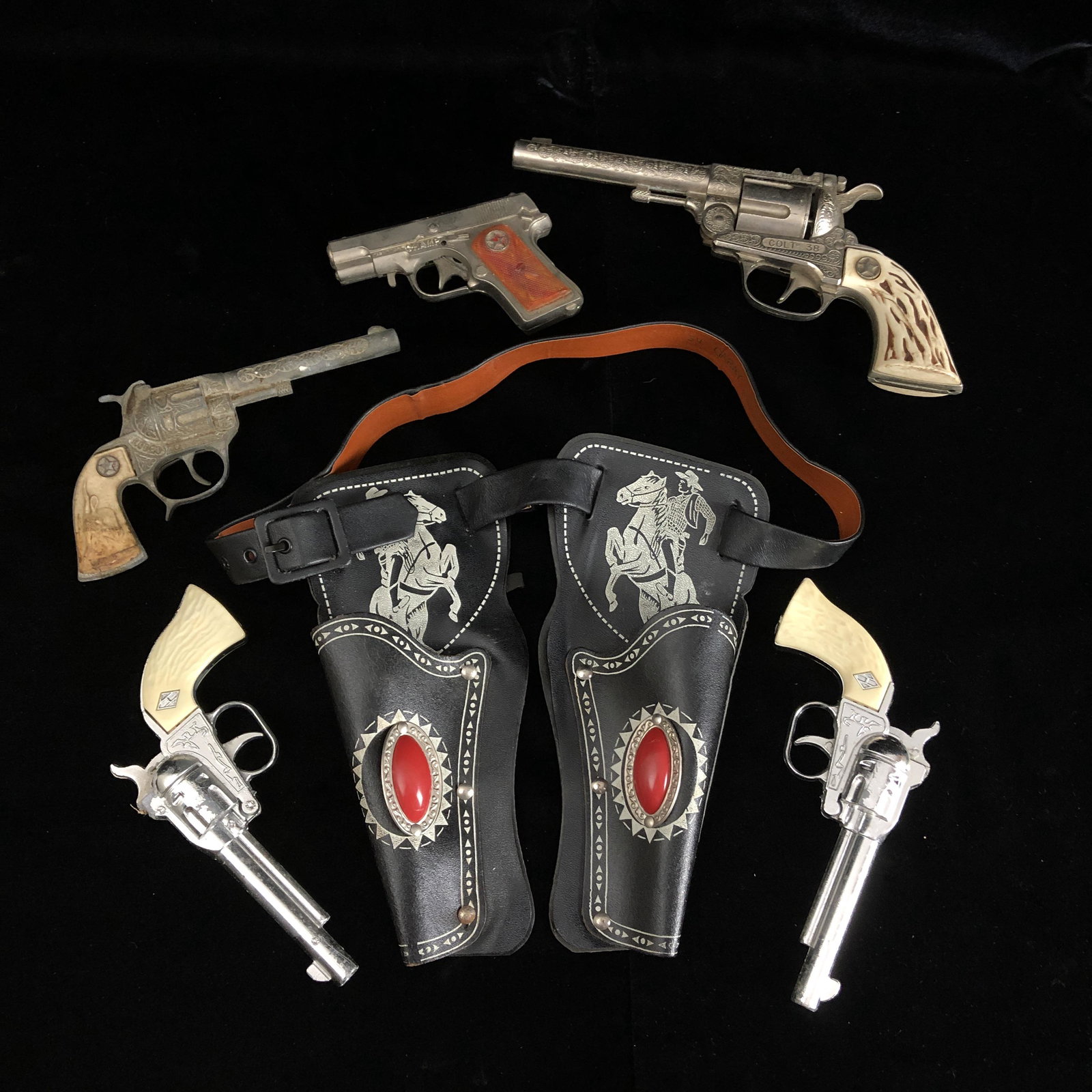 1940s 1950s American Cap Gun Lot: 1940s 1950s American Cap Gun Lot to include Champ Hubley Colt 38, Rodeo, and unmarked. All as-is. Missing pieces dirty, not functioning properly, all have at least one issue.