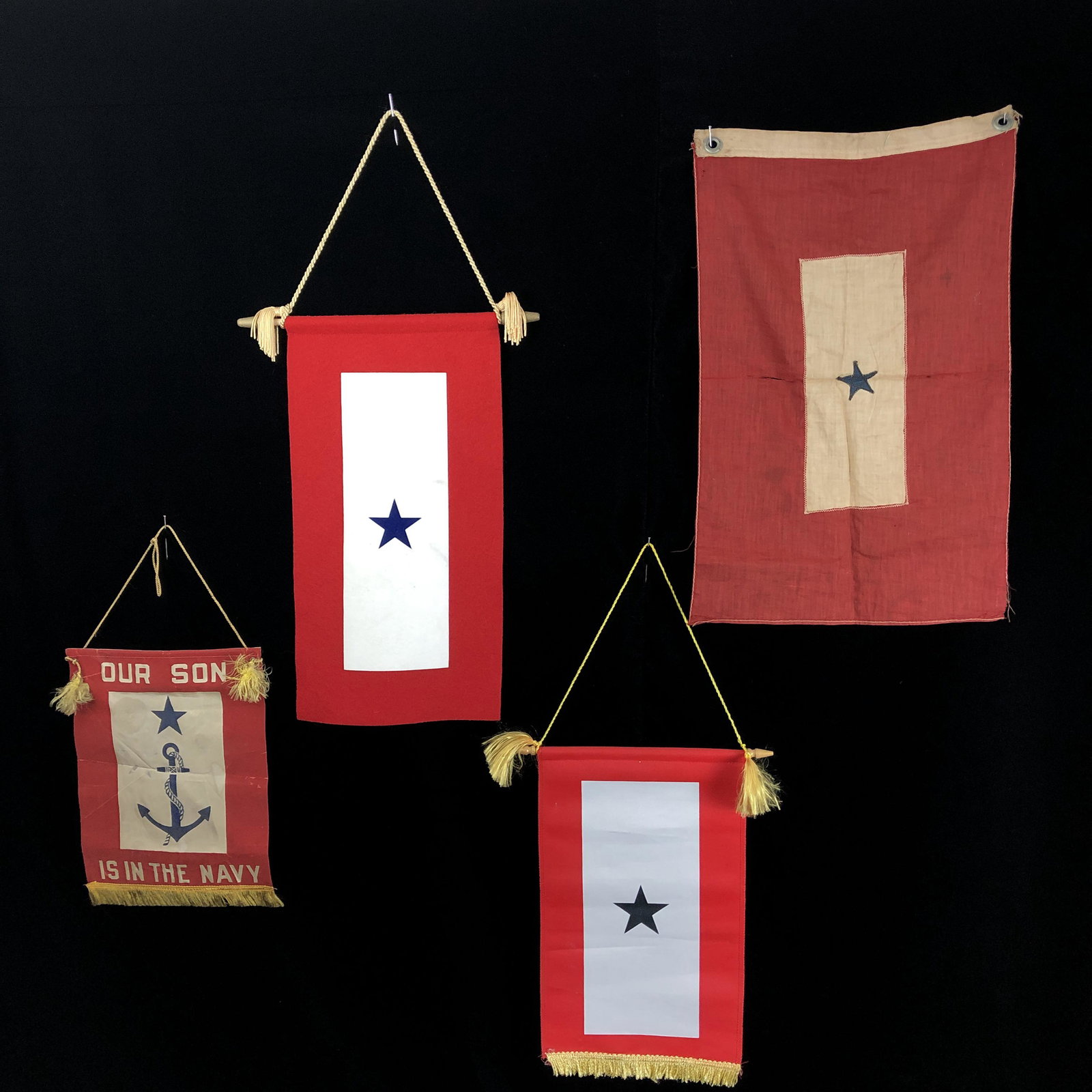 WWI WWII Son in Service Homefront Flag Lot: One WWI thin cotton Son in Service window flag small tear in center two grommets at top.One WWII USN Navy Son in Service flag, appears to be silk. Some mild staining. 2 WWII Son in Service flags. One 