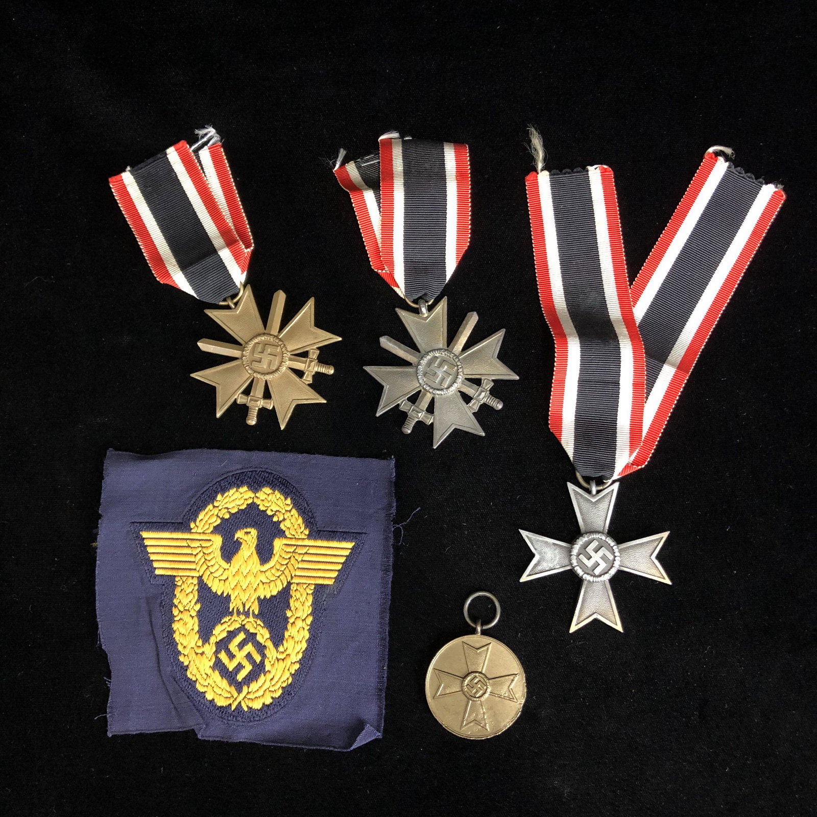 WWII German Police Patch, Merit Badge Medal Lot: Several WWII German merit medals two with swords one without one without ribbon. Plus WWII police patch. None glow under the black light. All in good shape.