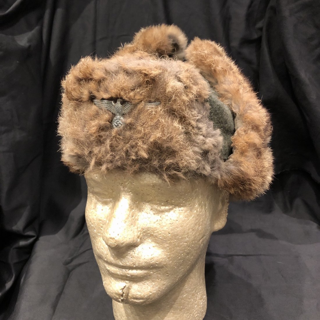 WWII German Heer Army Winter Rabbit Fur Cap w eagle 1943: German WWII Heer Winter Fur Cap. The body made of field grey wool with rabbit fur trim pull down ear and neck covering with a quilted rayon lining. Numbered size 56, in good shape. The rabbit fur is s