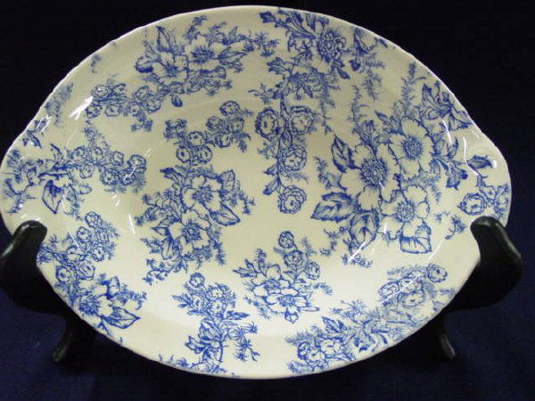Taylor, Smith, Taylor Open Vegetable Bowl: This bowl is in excellent condition with no cracks, crazing, or chips. It measures 9 1/2" long by 6 3/4" wide by 1 3/4" deep. The decor is a blue floral design and we do not know the pattern on this p