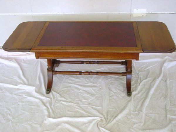 Leather Top Mahogany Drop Leaf Coffee Table: This Duncan Phyfe Coffee Table measures 49 1/2" L X 20" D X 17 1/4" T. with leaves up and it is in good condition. There does not appear to be any damage to the leather top and both leaves work well