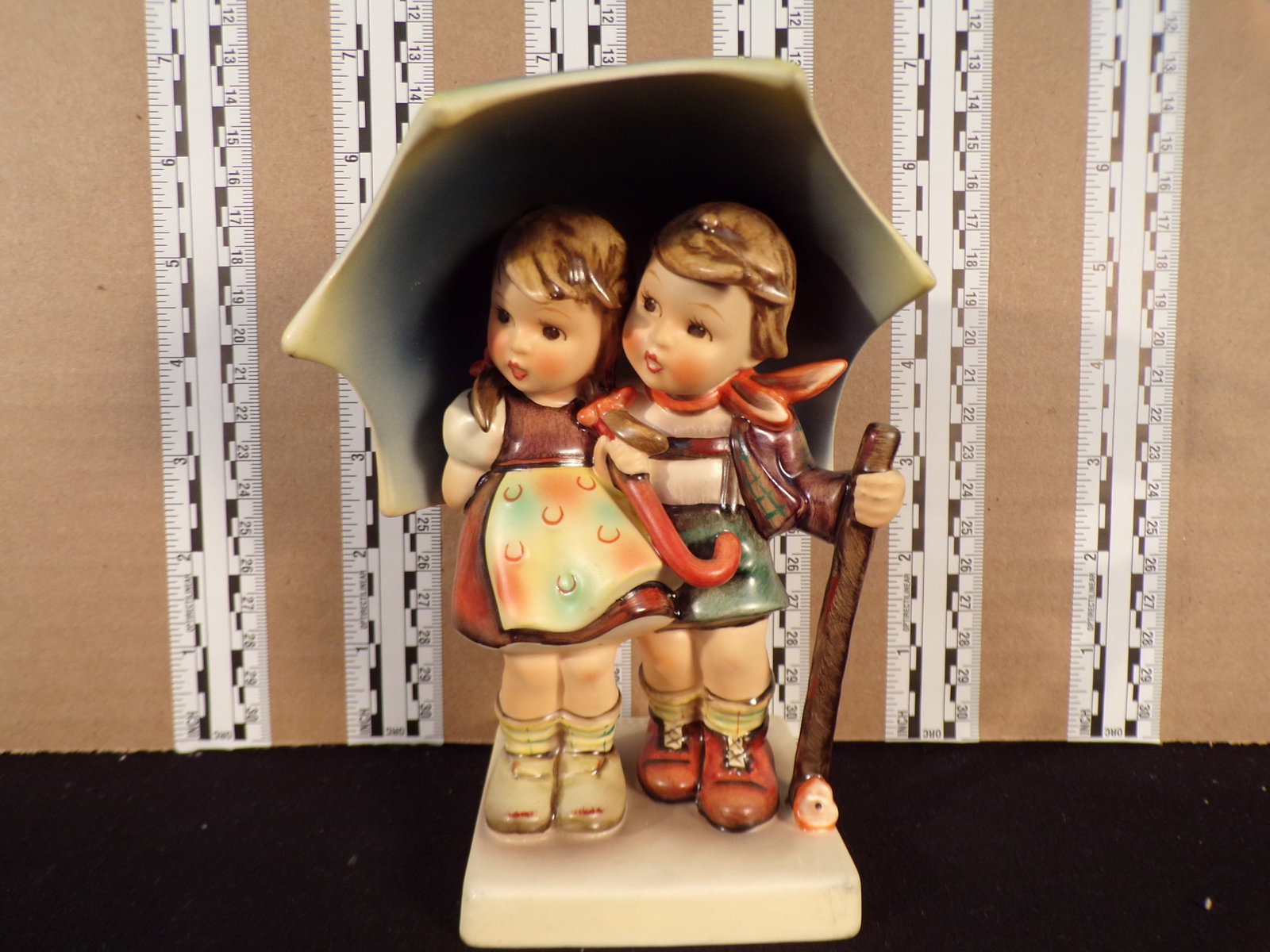 Hummel #71, Trademark # - 6, Figurine Name - Stormy Weather: Up for auction is Hummel #71, Trademark # - 6, Figurine Name - Stormy Weather, This hummel does not have a box and displays these special attributes: None. This Hummel is in excellent condition with n