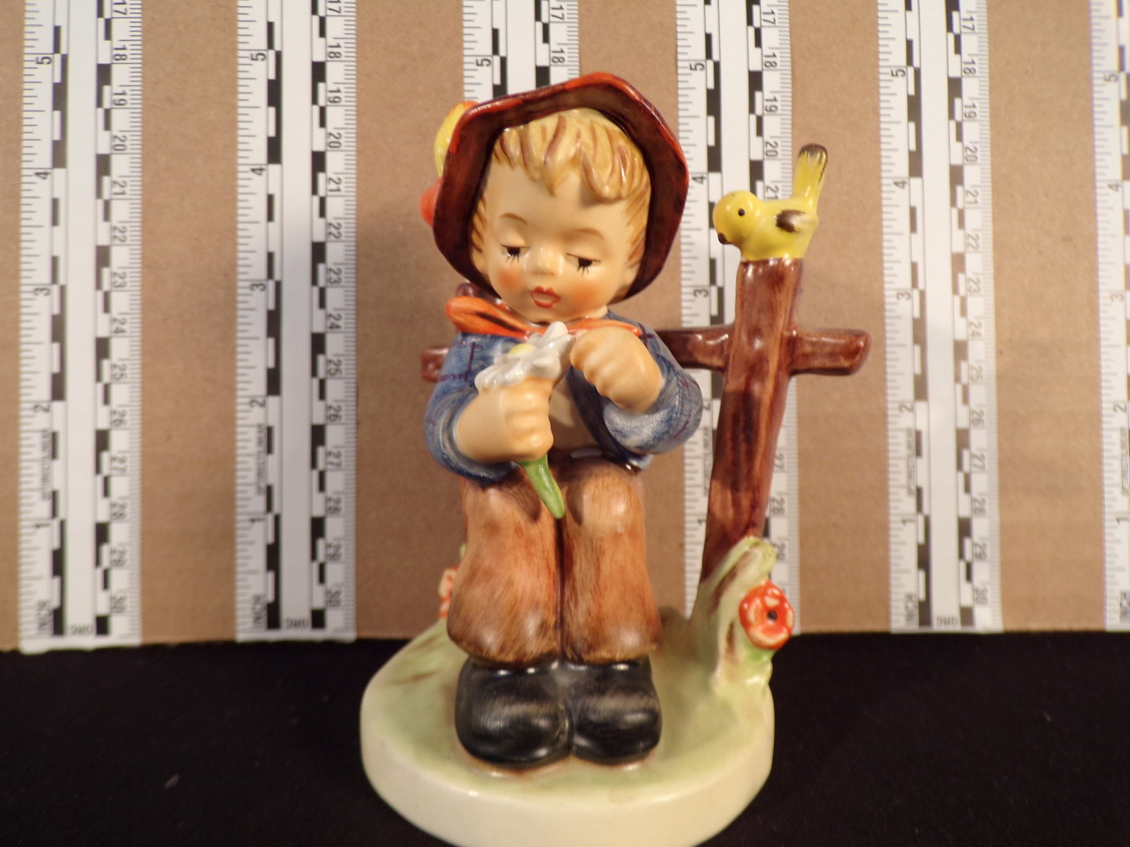 Hummel #174, Trademark # - 6, Figurine Name - She Loves Me, She Loves Me Not: Up for auction is Hummel #174, Trademark # - 6, Figurine Name - She Loves Me, She Loves Me Not, This hummel does not have a box and displays these special attributes: Pink And Green Bags. This Hummel 