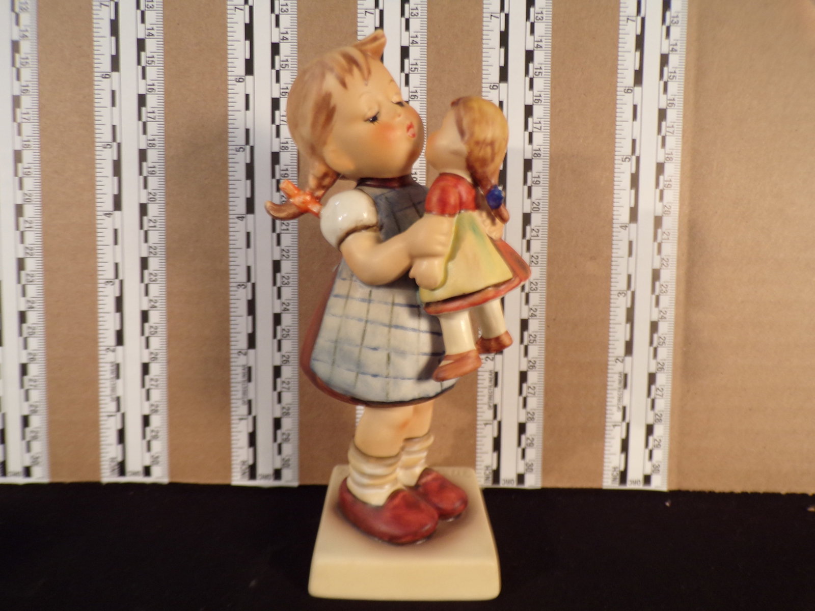 Hummel #311, Trademark # - 5, Figurine Name - Kiss Me: Up for auction is Hummel #311, Trademark # - 5, Figurine Name - Kiss Me, This hummel does not have a box and displays these special attributes: None. This Hummel is in excellent condition with no chip