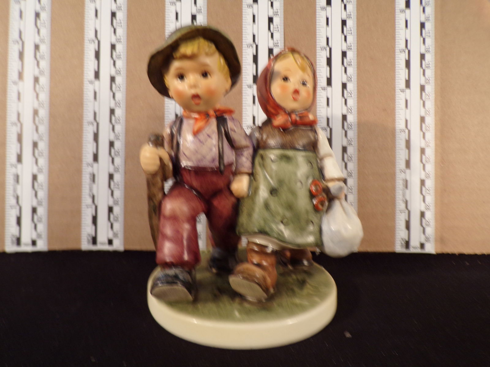 Hummel #383, Trademark # - 6, Figurine Name - Going Home: Up for auction is Hummel #383, Trademark # - 6, Figurine Name - Going Home, This hummel does not have a box and displays these special attributes: None. This Hummel is in excellent condition with no c