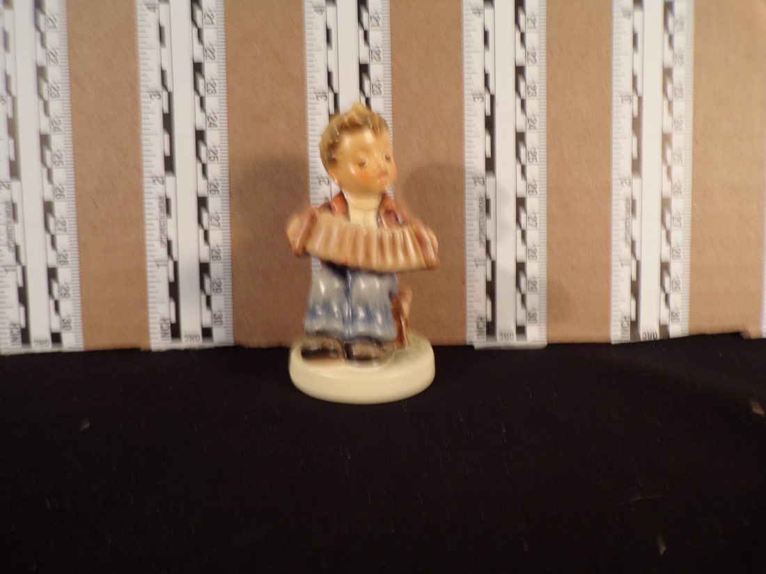 Hummel #857, Size Indicator # - 857 4/0 Trademark # - 8, Figurine Name - Accordion Ballad: Up for auction is Hummel #857, Size Indicator - 857 4/0, Trademark # - 8, Figurine Name - Accordion Ballad, This hummel does have a box and displays these special attributes: None. This Hummel is in e