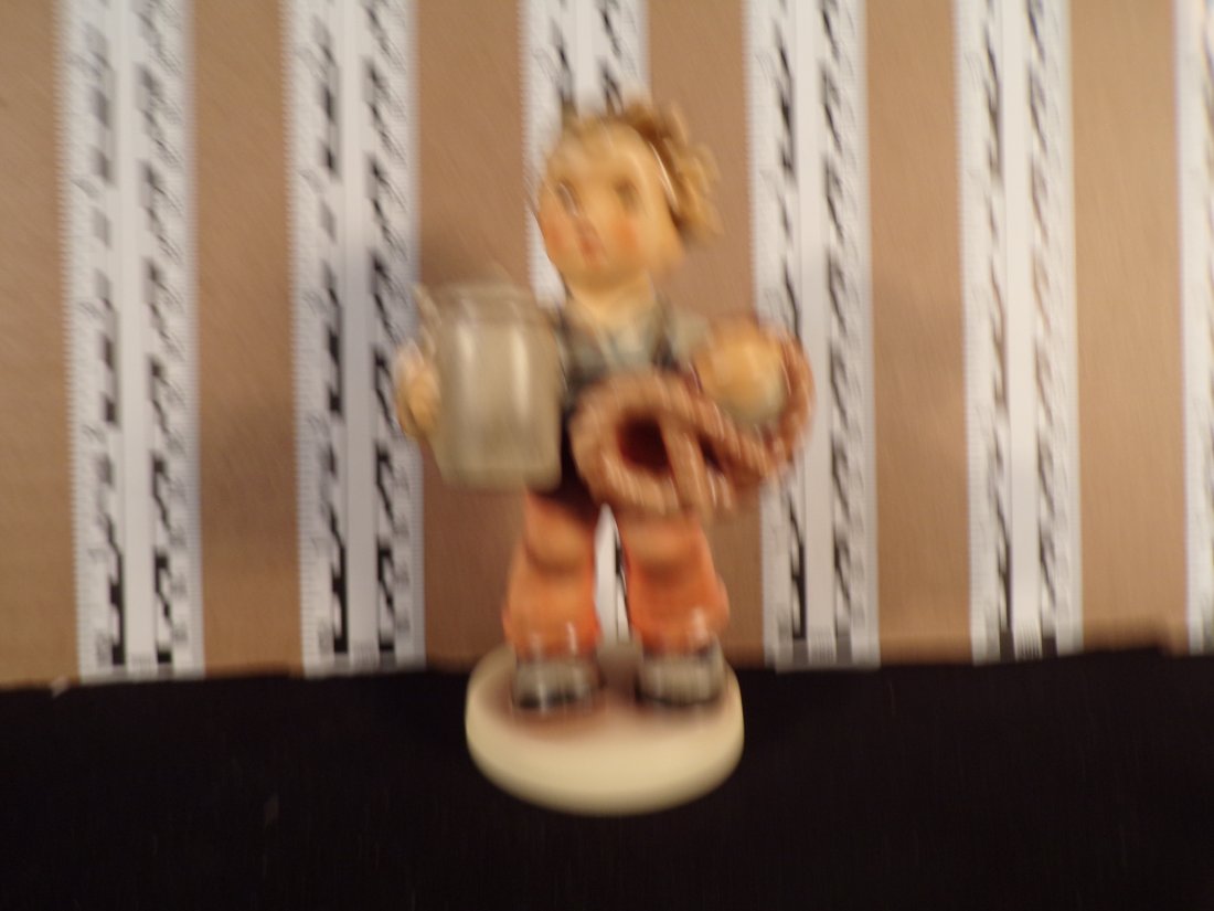 Hummel #2093, Trademark # - 8, Figurine Name - Pretzel Boy: Up for auction is Hummel #2093, Trademark # - 8, Figurine Name - Pretzel Boy, This hummel does not have a box and displays these special attributes: First Issue Millenium 2000 Stamp. This Hummel is in