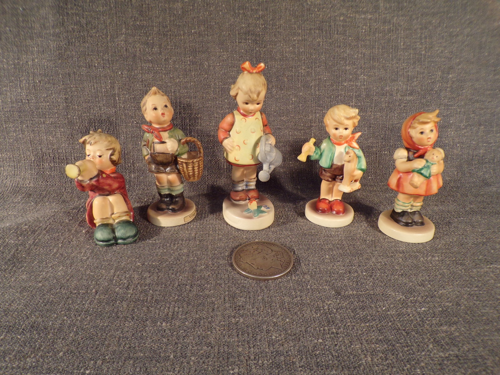 Lot of 5 Hummel Figurines 391, 51/3/0, 74, 239/B, and 239/C -Various Trademarks.: Up for auction is one (1) Lot of 5 Hummel Figurines 391, 51/3/0, 74, 239/B, and 239/C -Various Trademarks. You get 391 Girl with Trumpet, 51/3/0 Village Boy, 74 Little Garderner, 239/B Girl With Doll 