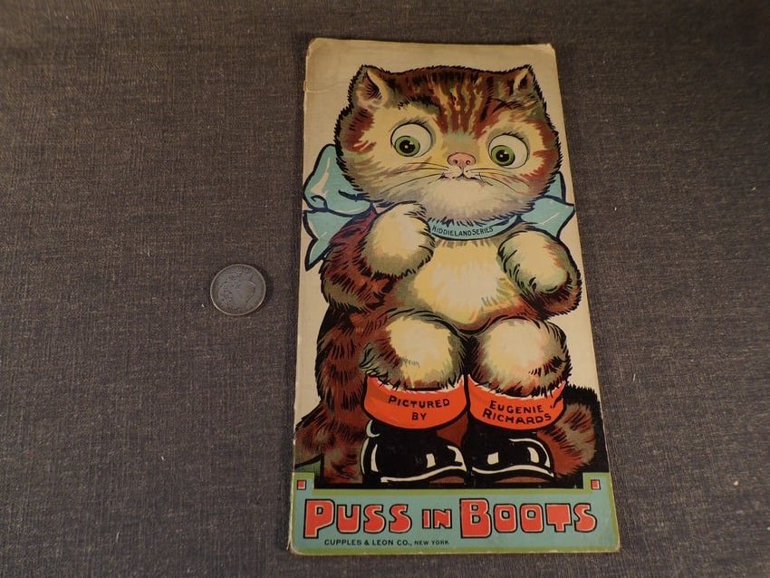 Antique 1915 Book Puss in Boots published by Cupples & Leon Company.: Antique 1915 Book Puss in Boots published by Cupples & Leon Company. This book is in Good or better condition as pictured. 15" tall by 8" wide and contains 12 pages. Cover is partly separated from spi
