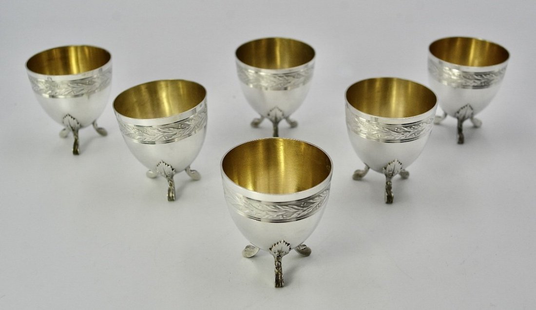 Antique France Early 20th Century Set Of Six 950 Silver Egg Cups Minerva hallmarks: Set of six silver egg cups resting on three feet decorated with acanthus leaves, body in the shape of a half-egg, the upper part is decorated with a laurel frieze on a guillochÃ© background.950/1000