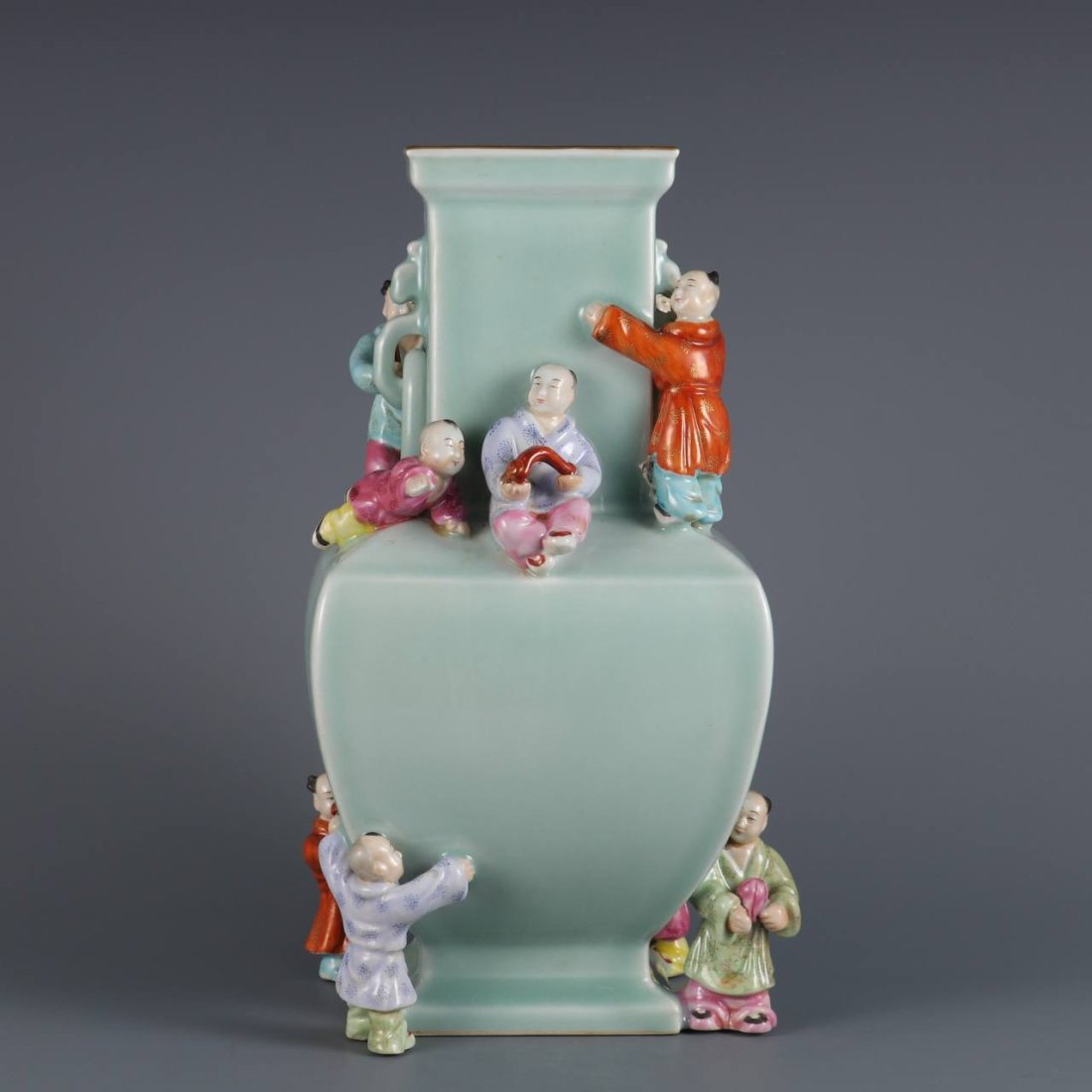 A holly-glazed yangcai multi-sculpture square vase made by Emperor Qianlong of the Qing Dynasty: A holly-glazed yangcai multi-sculpture square vase made by Emperor Qianlong of the Qing Dynasty. Dimensions: Height: 29.2cm, diameter: 8.6cm
