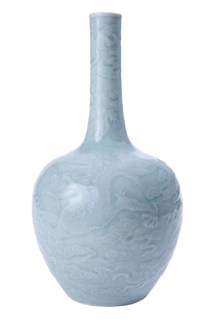 A vase of the QING dynasty in the shape of a bottle with a relief image of dragons: A porcelain vase of the QING dynasty, QIANLONG, of high quality, made in the CELADON technique. The case is decorated with a relief image of dragons and FU-BATS (bats), in flight, in the clouds.Dimens