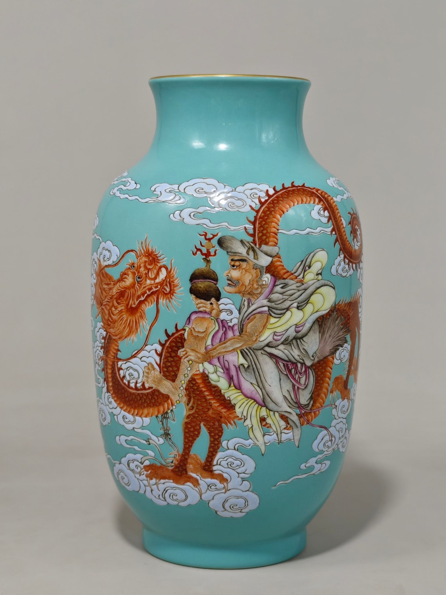 A lantern vase with a turquoise-green base and auspicious dragon and arhat patterns made during the: 24 cm high and 15 cm in diameter.