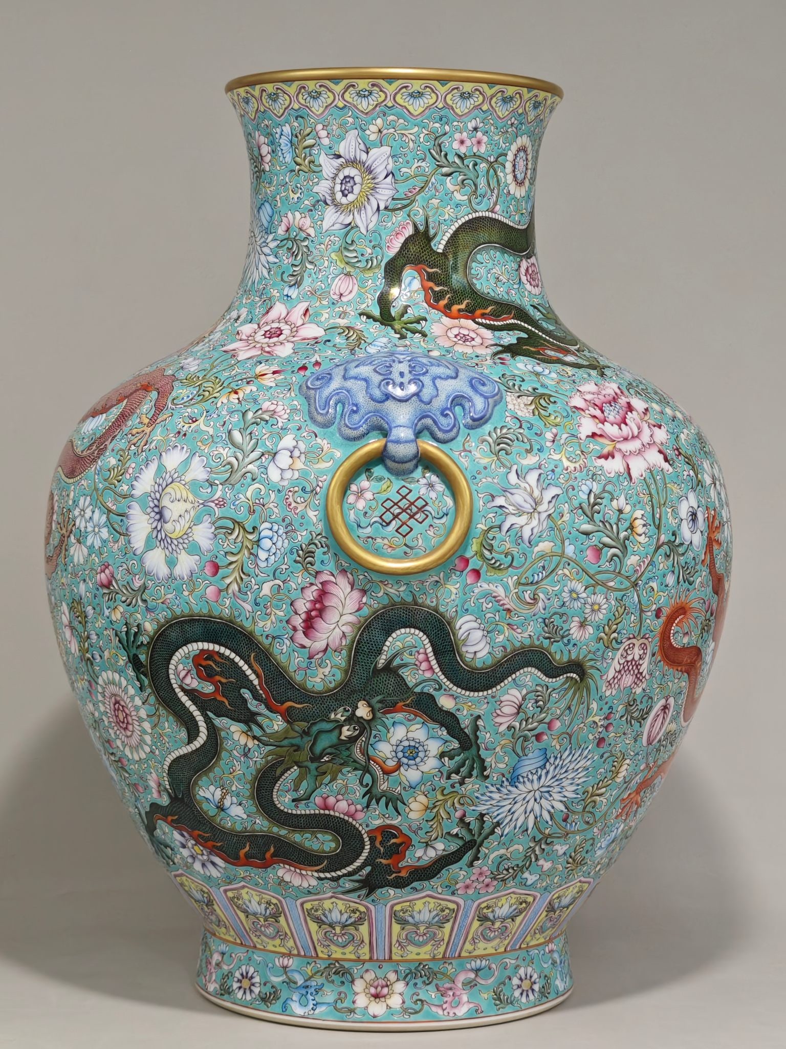 A Qing Dynasty Qianlong-era famille rose vase with five dragons, entwined lotus and floral designs,: 51 cm high and 39 cm in diameter.