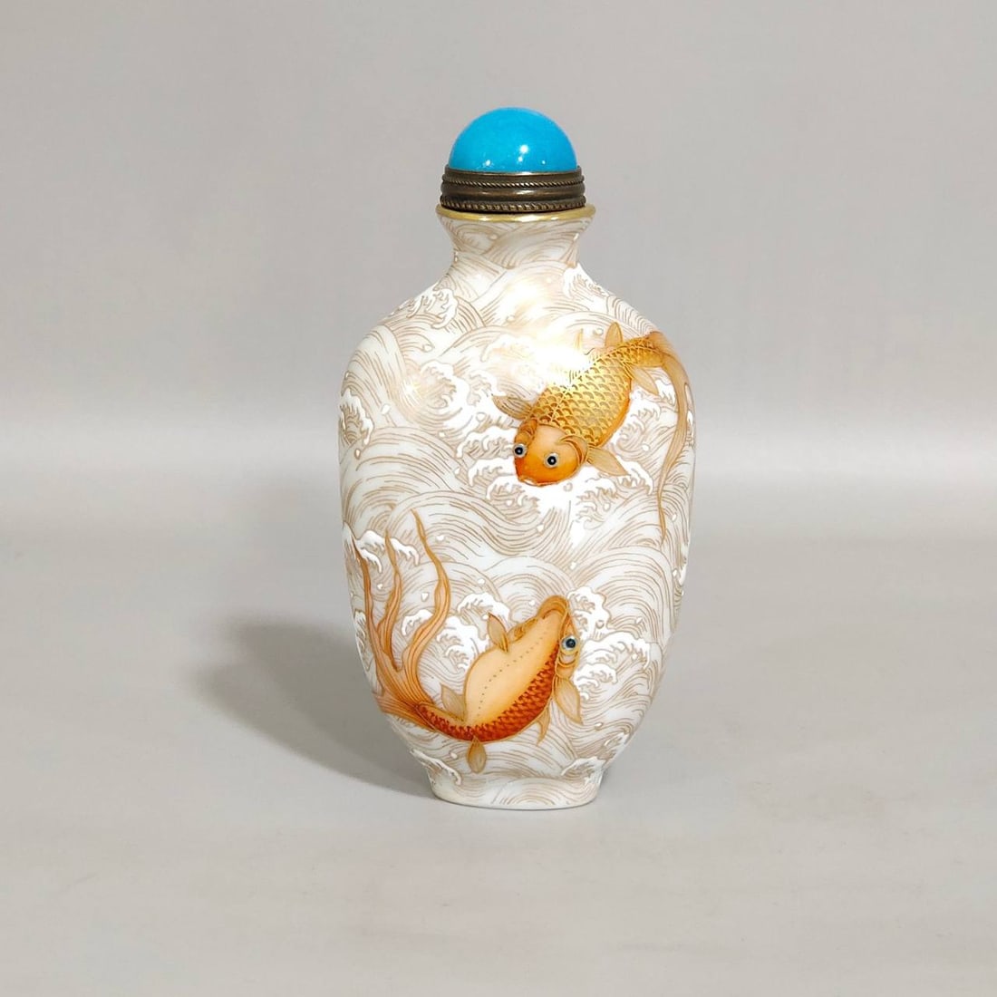 A Qing Dynasty Qianlong period gilt goldfish snuff bottle with wave pattern (1 of 8)