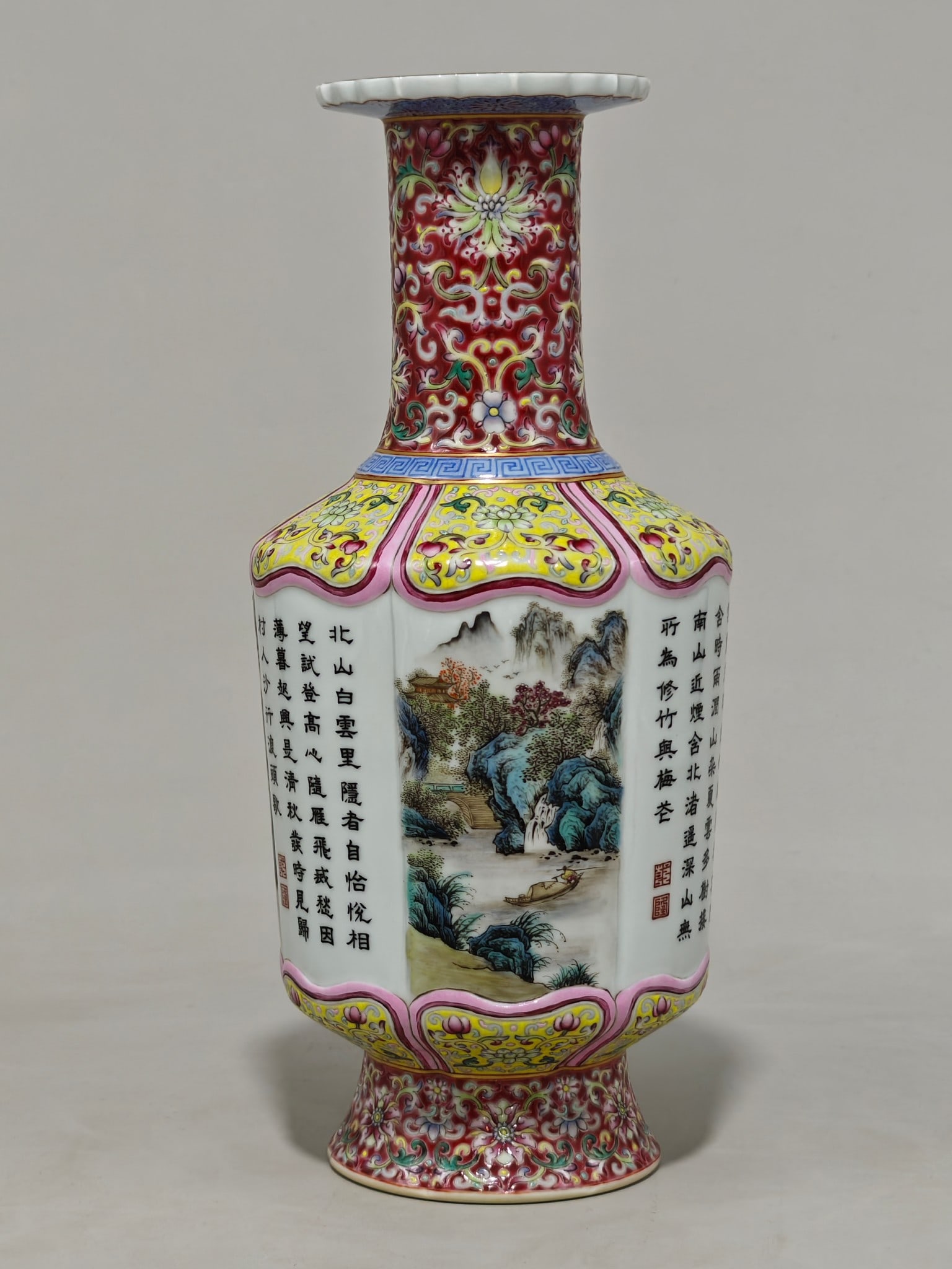 A famille rose vase with a landscape and poem design and a windowed design, bearing the mark of the: It measures 28 cm in height and 13 cm in diameter.
