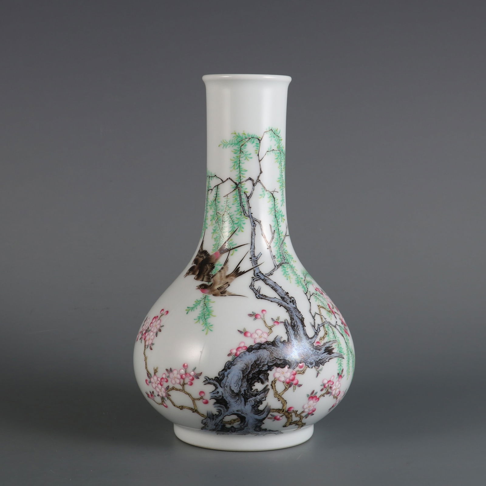 A Qing Dynasty Yongzheng period famille rose enamel vase with apricot blossoms and swallows design. (1 of 9)