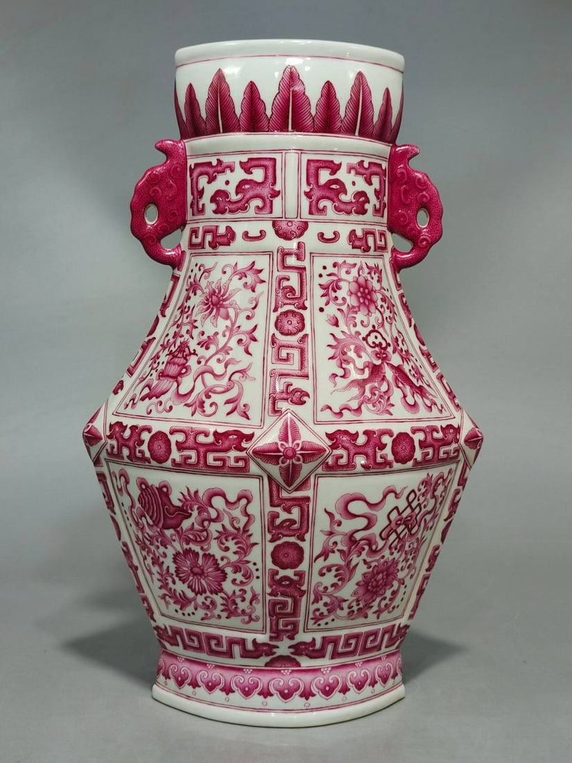 A Qing Dynasty Qianlong period famille rose vase with a rouge-red lotus scroll and eight auspicious: A Qing Dynasty Qianlong period famille rose vase with a rouge-red lotus scroll and eight auspicious symbols, shaped like a rhombus and with double handles. The vase is 39.5 cm high and 26 cm in diamet