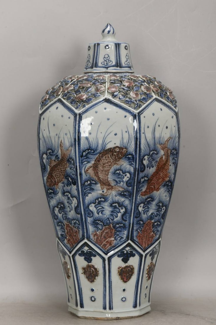 A Yuan dynasty blue-and-white underglaze red octagonal plum vase with fish and floral designs: A Yuan dynasty blue-and-white underglaze red octagonal plum vase with fish and floral designs, 49 cm high, 24 cm in diameter at the belly, and 13 cm in diameter at the base.