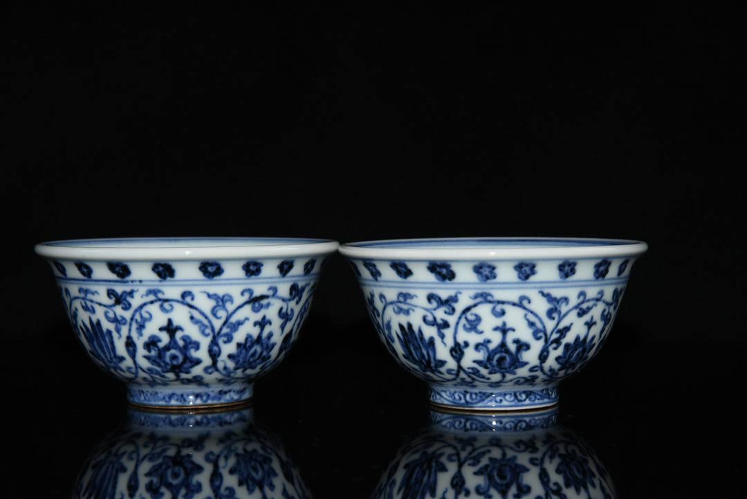 A pair of blue and white porcelain cups with lotus scroll design: A pair of blue and white porcelain cups with lotus scroll design, made during the Yongle reign of the Ming Dynasty. Dimensions: 9.5x5cm