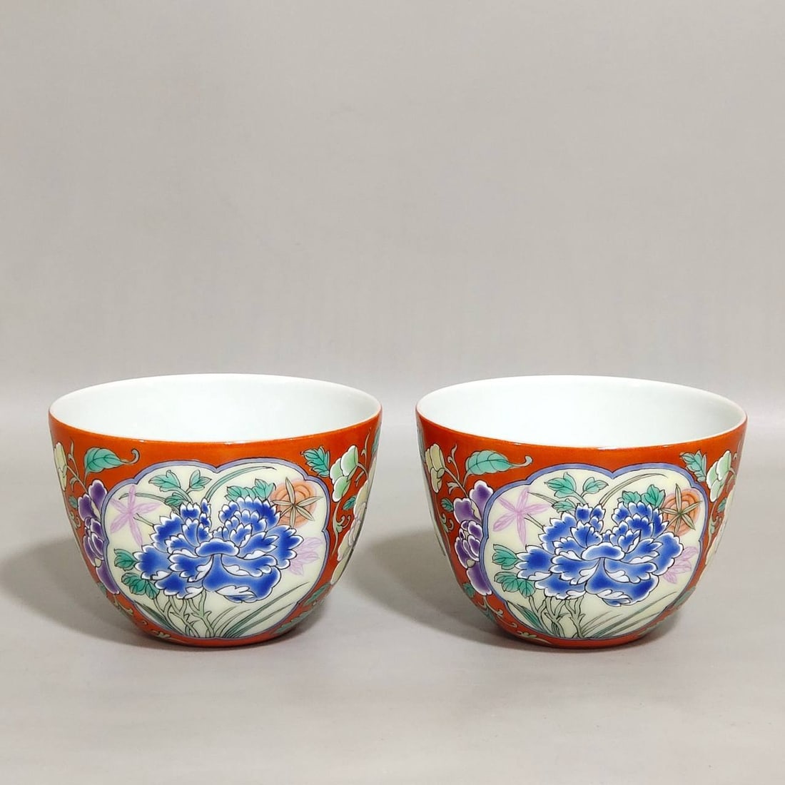 A Qing Dynasty Yongzheng period imperial enamel-painted coral-red ground wine cups: A Qing Dynasty Yongzheng period imperial enamel-painted coral-red ground wine cup with openwork floral design, 5 cm high and 7.3 cm in diameter,