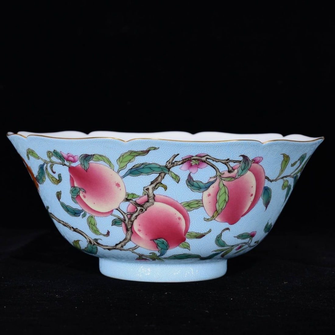 A Qianlong period famille rose bowl with nine peaches and a lobed rim: A Qianlong period famille rose bowl with nine peaches and a lobed rim, 8 cm high and 18 cm in diameter.