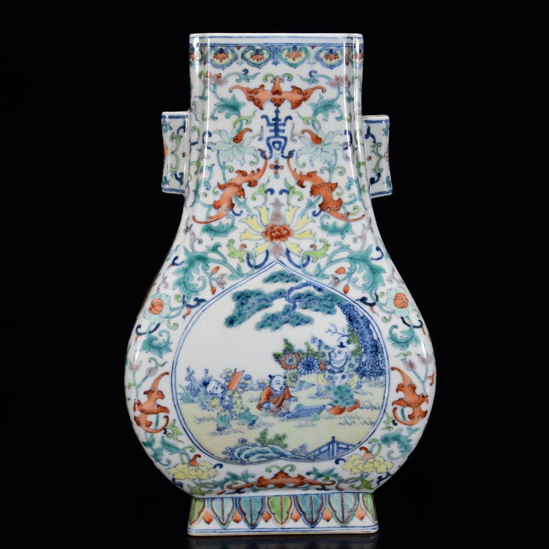 A square flat bottle with doucai (enamel overglaze) design of children and tubular handles: A square flat bottle with doucai (enamel overglaze) design of children and tubular handles, dating to the Qianlong period of the Qing Dynasty, measuring 29 x 18 cm.