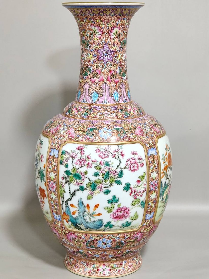 A Qing Dynasty Qianlong period vase with a windowed design of phoenix tail grass and seasonal flower (1 of 8)