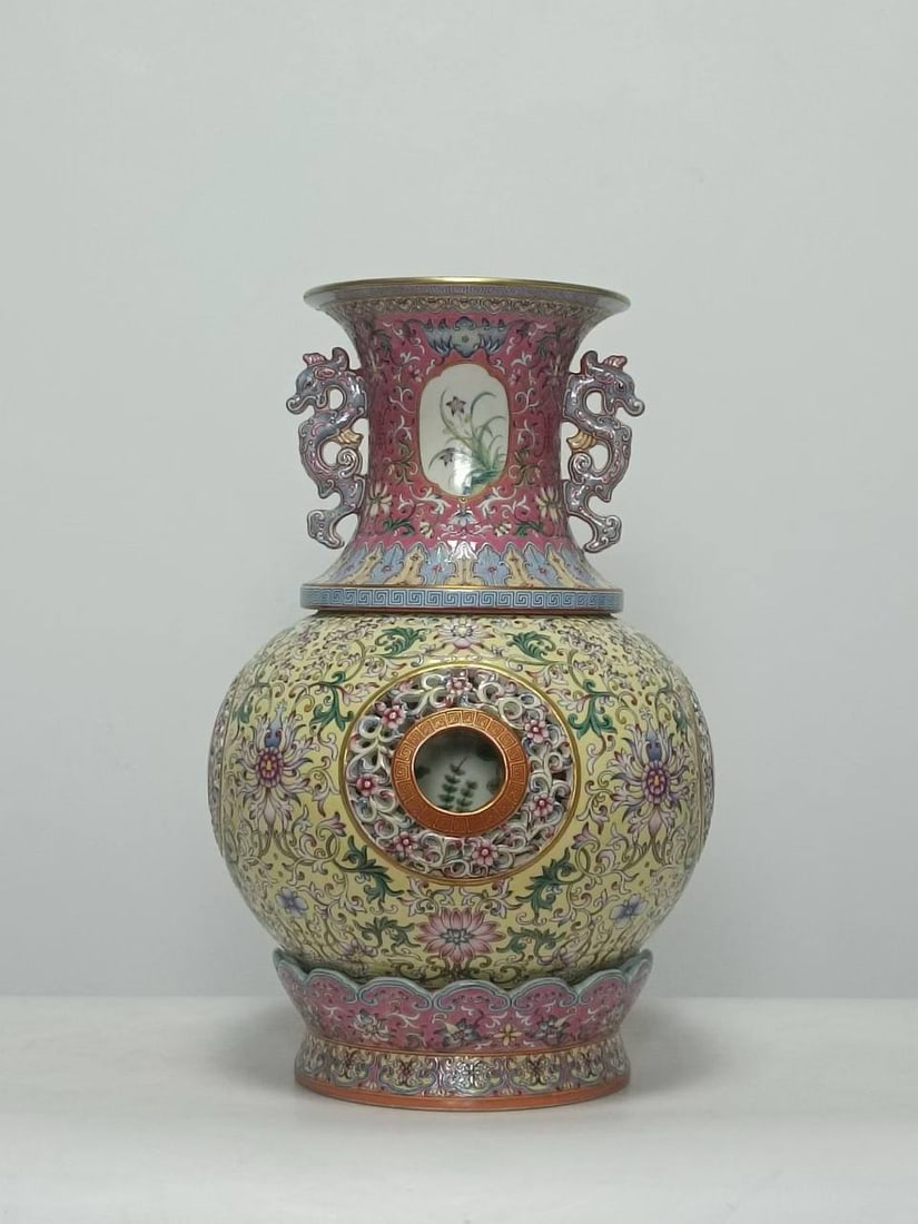 A famille rose vase with a red and yellow ground, decorated with openwork on all four sides: A famille rose vase with a red and yellow ground, decorated with openwork on all four sides and featuring a double-eared design, bearing the mark of the Qianlong period of the Qing dynasty. Height: 40