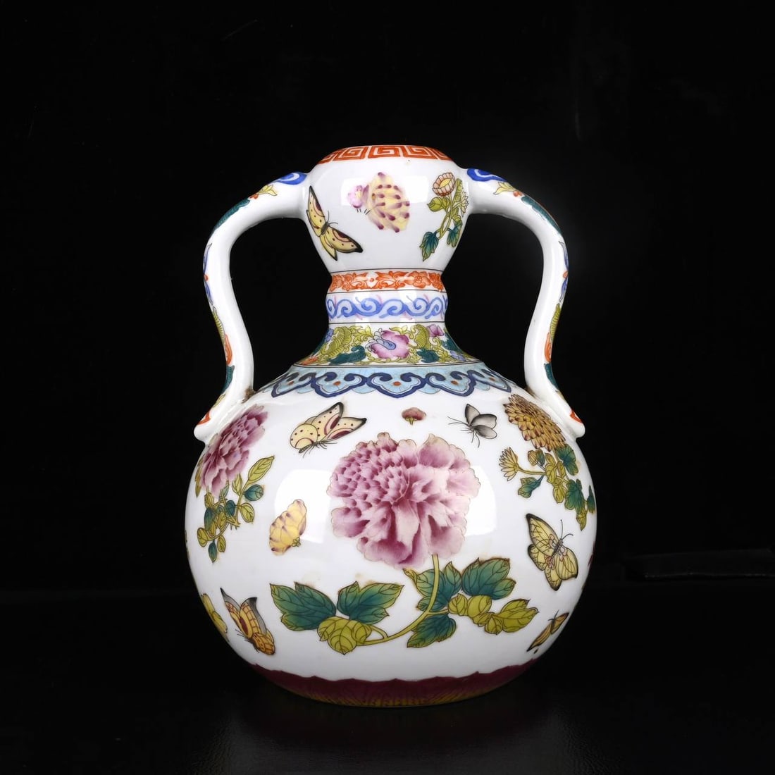 A Qianlong period (1730-1700) famille rose enamel vase with butterfly and flower design (1 of 8)
